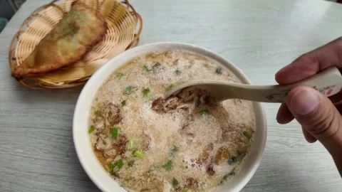 Fried Dumpling and Savory Soup Form Traditional Shanghai Breakfast Stock Footage 340176642