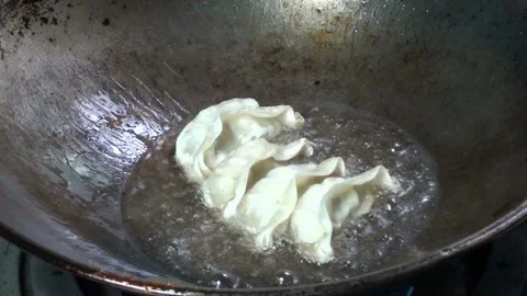 Fried dumplings in a pan Stock Footage 220590752