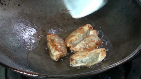 Fried dumplings in a pan Stock Footage 220590756
