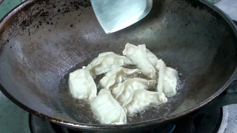Fried dumplings in a pan , time lapse Video stock 220590734