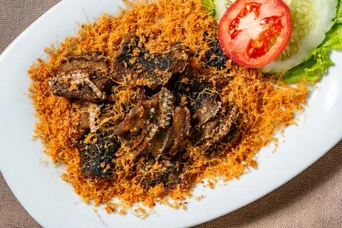 Fried eel with grated galangal or belut goreng lengkuas Stock Photos