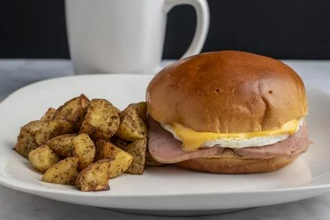 Fried  egg and spam breakfast sandwich  with home fries Stock Photos