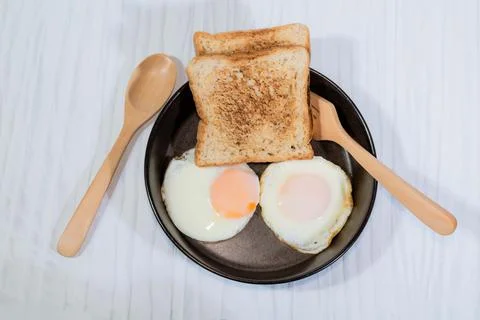 Fried egg bread in bowl isolated on white background. Stock Photos
