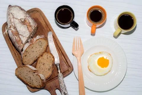 Fried egg bread slice in cutting board have espresso coffee on white background. Stock Photos