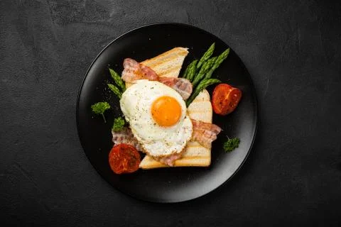 Fried egg with bread toast and asparagus Stock Photos