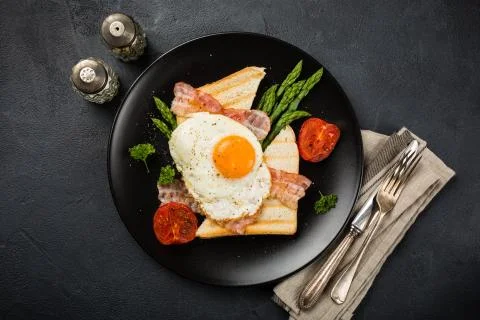 Fried egg with bread toast and asparagus Stock Photos