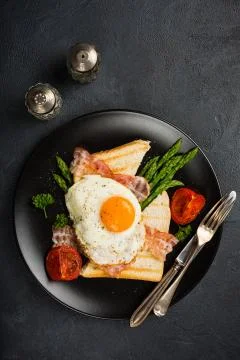 Fried egg with bread toast and asparagus Stock Photos