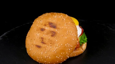 Fried Egg Burger with meat, bacon, cheese and fresh vegetables Stock Footage 84652911