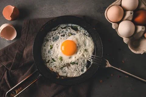 Fried egg in a cast-iron pan rustic style, selective focus, horizontal, no .. Stock Photos