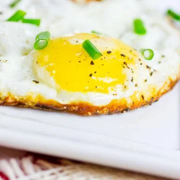 Fried egg with chives Stock Photos