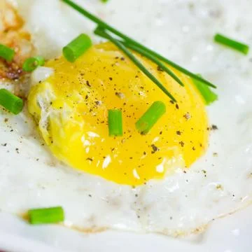 Fried egg with chives Stock Photos