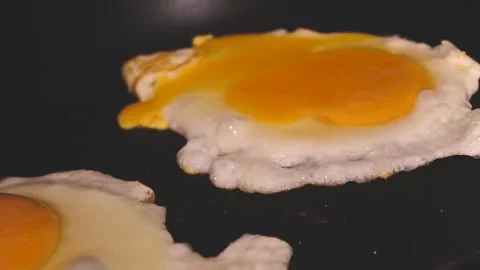 Fried egg cooking in dim light 4K Stock Footage 319527936