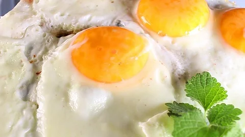 Fried egg eggs food closeup texture pattern seamless looping rotating video Stock Footage 102744129