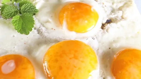 Fried egg eggs food closeup texture pattern seamless looping rotating video Stock Footage 102744233