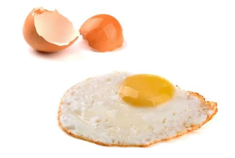 Fried egg Fried egg and egg shell isolated on white Copyright: xZoonar.com... Stock Photos