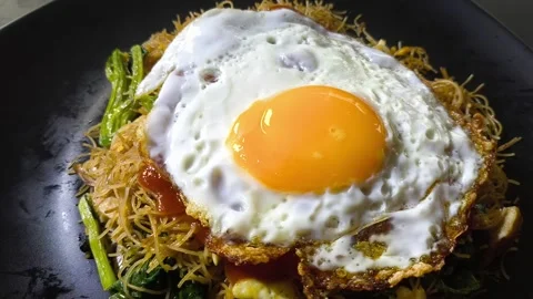 Fried egg on fried vermicelli, in door  Chiangmai  Thailand. Stock Footage 305450190