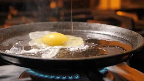 Fried egg on a frying pan. Breakfast time Stock Footage 136555341
