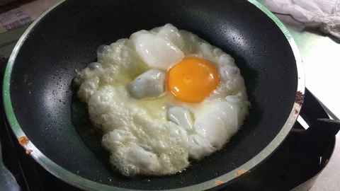 Fried egg on a frying pan Stock Footage 97627712