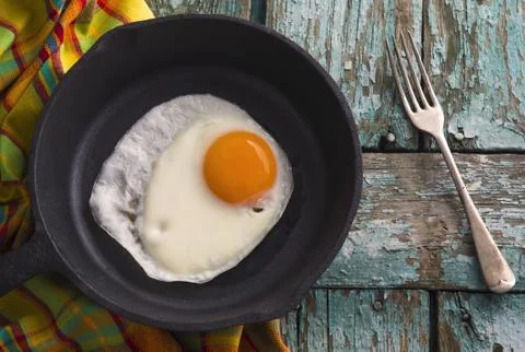 Fried egg in a frying pan Stock Photos