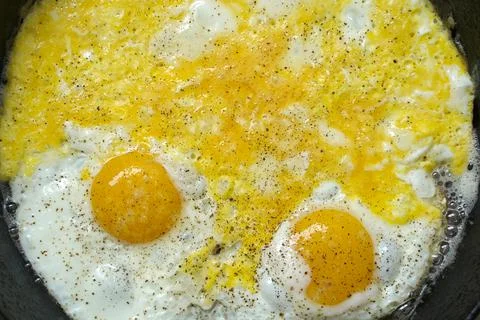 Fried egg on a frying pan Stock Photos
