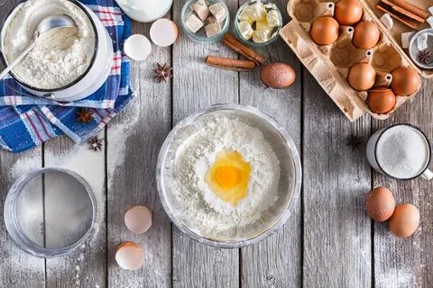 Fried egg on a gray wooden table with baking supplies Stock Photos