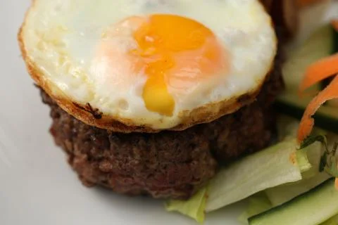 Fried egg on ground meat steak food Stock Photos