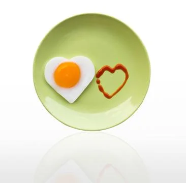 Fried egg heart and source heart Stock Photos