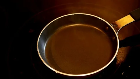 Fried egg in a hot pan. Fresh egg is broken and dropped into the frying pan. Stock Footage 103398802