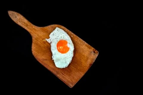 Fried egg isolated on black background Stock Photos