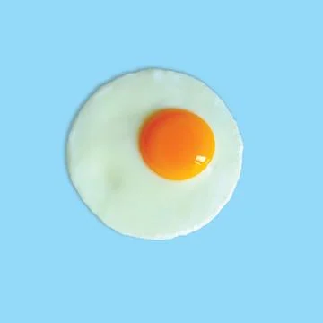 Fried egg on light blue background Stock Photos