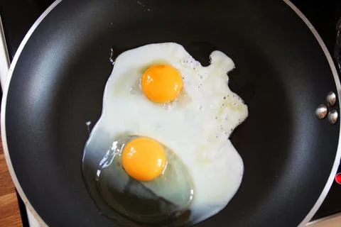 Fried egg on pan Stock Photos