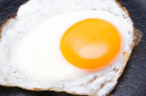 Fried egg on pan Stock Photos