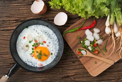 Fried egg in pan on wood background 写真素材