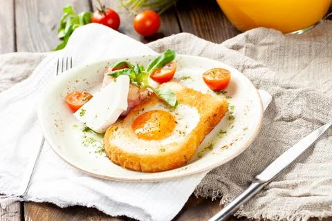 Fried egg in a piece of bread in a plate Stock Photos