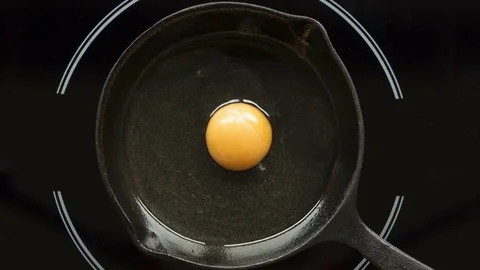 Fried egg on a pig-iron frying pan preparation process time lapse Stock Footage 82721548