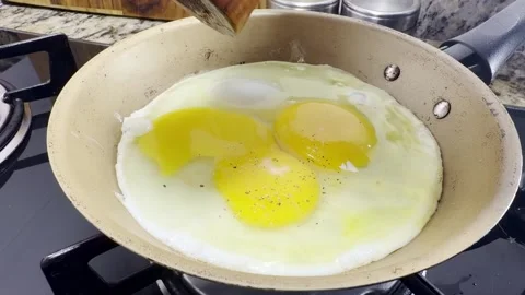 Fried egg putting pepper Slowm Stock Footage 336557462