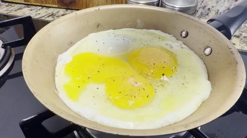 Fried egg putting salt Slowm Stock Footage 336674068