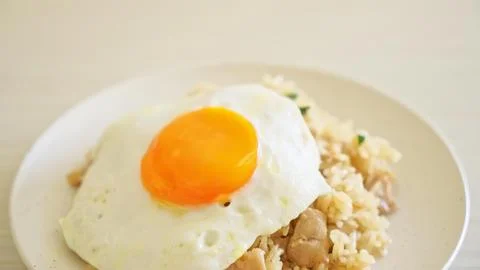 Fried egg on rice with beans in a white bowl Stock Photos
