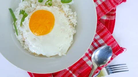 Fried egg rice. breakfast fried egg sunny side rice on a plate, isolated on.. Stock Photos