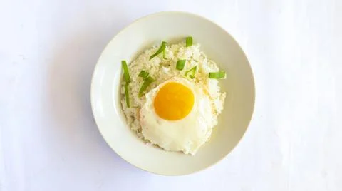Fried egg rice. breakfast fried egg sunny side rice on a plate, isolated on.. Stock Photos