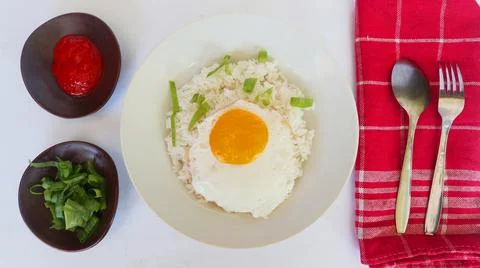 Fried egg rice. breakfast fried egg sunny side rice on a plate, isolated on.. Stock Photos