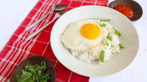 Fried egg rice. breakfast fried egg sunny side rice on a plate, isolated on.. Stock Photos