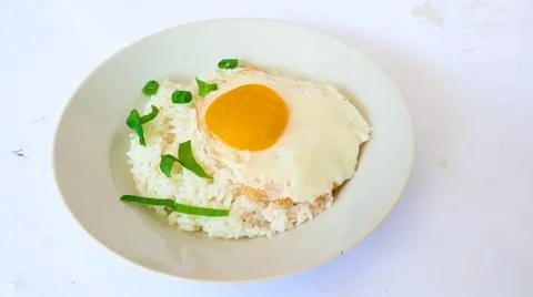 Fried egg rice. breakfast fried egg sunny side rice on a plate, isolated on.. Stock Photos