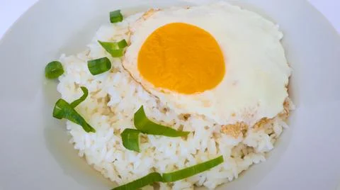 Fried egg rice. breakfast fried egg sunny side rice on a plate, isolated on.. Stock Photos