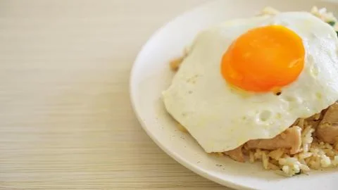 Fried egg on rice with meat on a white plate Stock Photos