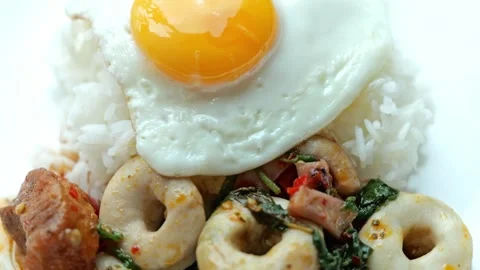 Fried Egg Rice with Pork Fish Cake Basil Chicken and Vegetables on Plate Video stock 346307245