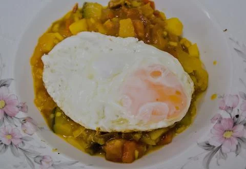 Fried egg on roasted vegetables Stock Photos