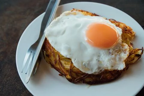 Fried egg on round white plate on wooden table. Fried eggs for breakfast Stock Photos