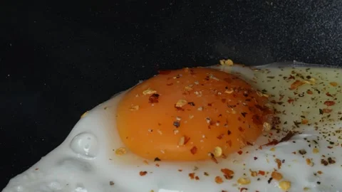 Fried Egg with Salt and Pepper Stock Footage 249926813