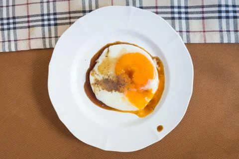 Fried egg with sauce on dish Stock Photos
